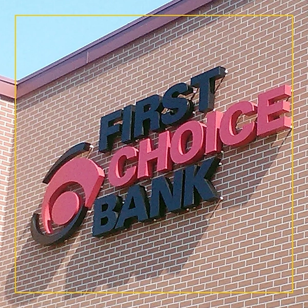 A brick wall with the words " first choice bank ".