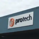A sign that says protech on the side of a building.