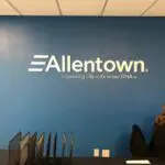 A wall with the company name allentown on it.