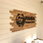 A sign that says panda pediatrics on the wall.