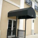 A black awning on the side of a building.