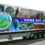 A large trailer truck with the words " come out and run ".