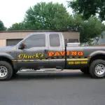 A truck with the words " chuck 's paving ".