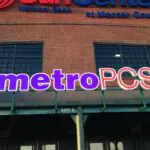 A metro pcs store front with the logo on it.