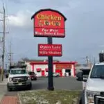 A sign on the side of the road advertising chicken.