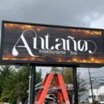 A large sign that says antano restaurant and bar.
