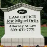 A sign for the law office of jose miguel ortiz.
