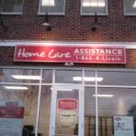 A home care assistance sign on the front of a building.