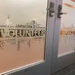 A door with words written on it and the word volunteer