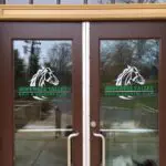 A pair of doors with horse logo on them.