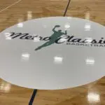 A floor with the logo of metro classic basketball.